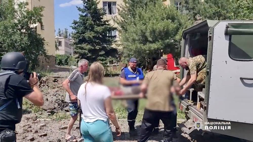 A person is carried on a stretcher towards a vehicle, as Russia’s invasion of Ukraine continues, in Bakhmut, Donetsk Oblast, Ukraine in this still image obtained from a social media video released on July 2, 2022. ― Reuters pic