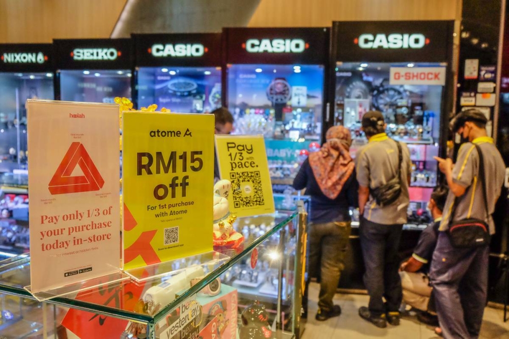 The Hoolah and Atome app logos are displayed at the shop in Shah Alam June 23, 2022. —  Picture by Yusof Mat Isa