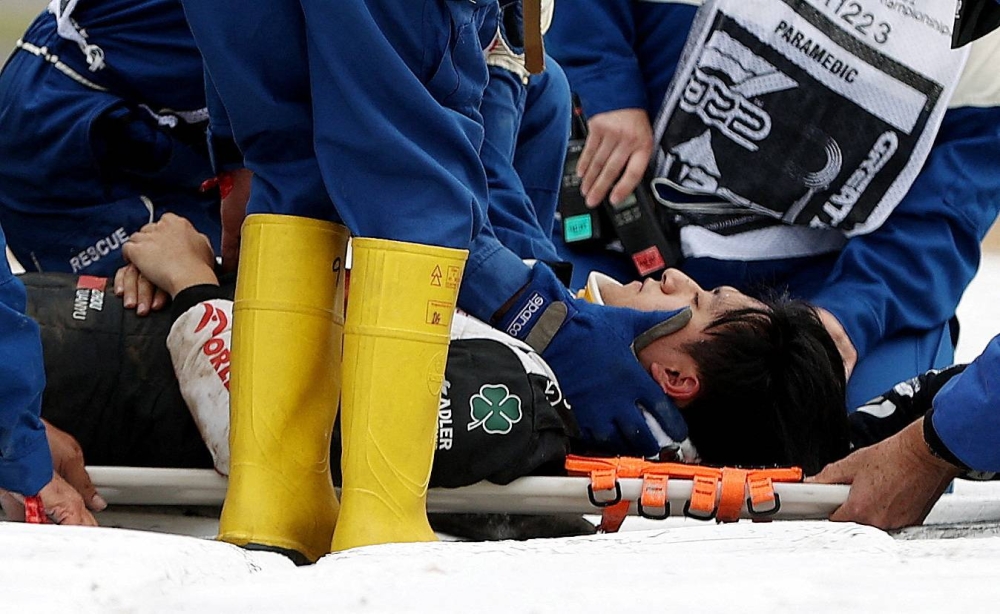 Alfa Romeo's Guanyu Zhou receives medical treatment after crashing out at the start of the British Grand Prix at the Silverstone Circuit July 3, 2022. — Reuters pic 