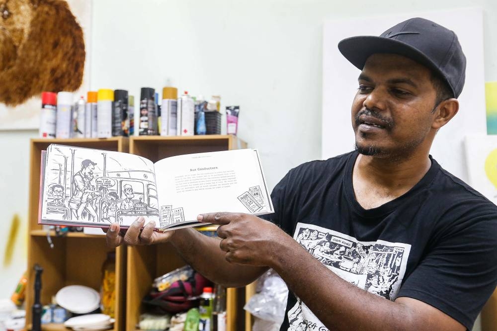 Malaysian artist Azmi Hussin shows some of his drawings in his new project ‘Tanjong Life Back To The 90s’ at his studio in Air Itam July 4, 2022. — Picture by Sayuti Zainudin