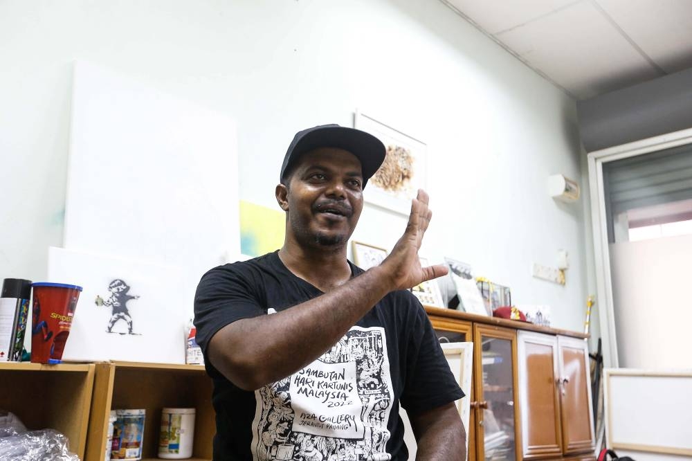 Malaysian artist Azmi Hussin speaks to the Malay Mail regarding his new project ‘Tanjong Life Back To The 90s’ at his studio in Air Itam July 4, 2022. — Picture by Sayuti Zainudin