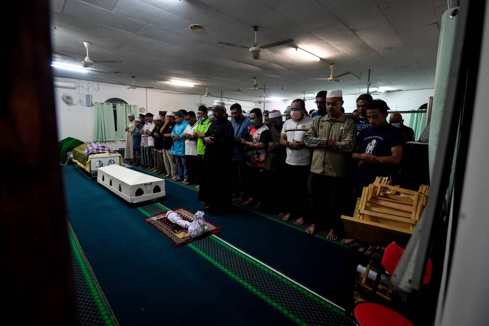 People attend funeral prayers for the trio at Surau Al-Istiqamah in Baling July 6, 2022. — Bernama pic