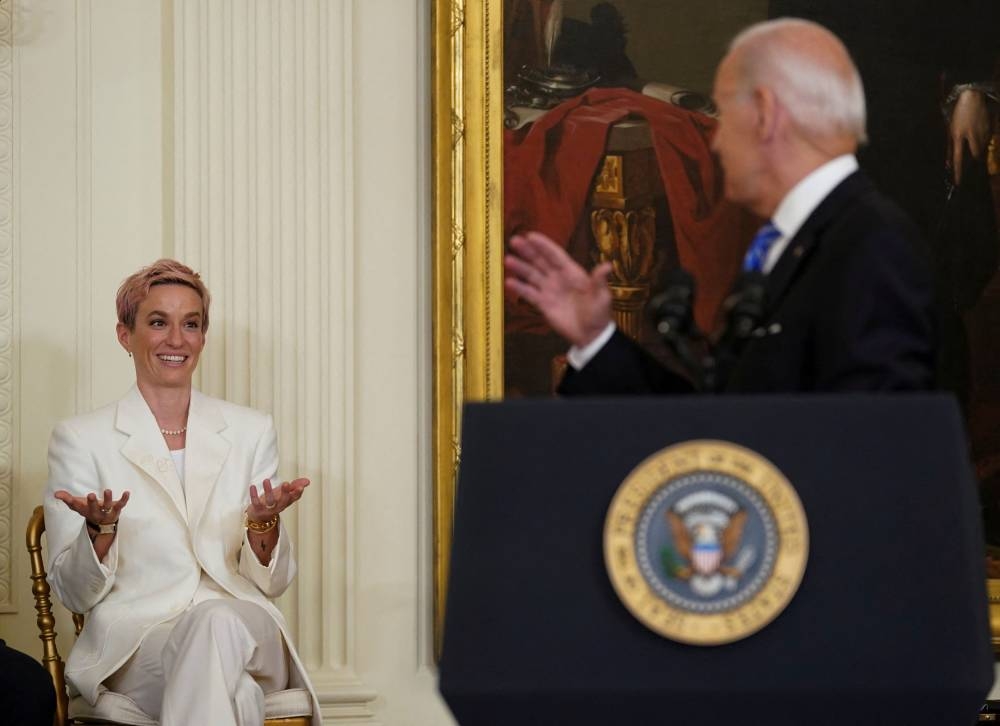 Megan Rapinoe reacts as she is acknowledged by US President Joe Biden during a ceremony honoring Presidential Medal of Freedom recipients in the East Room at the White House in Washington July 7, 2022. — Reuters pic 