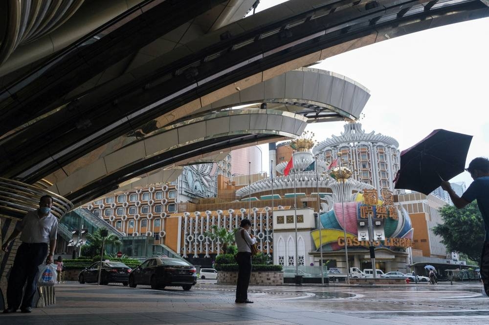People stand near Casino Lisboa, amid the Covid-19 outbreak, in Macau, China July 4, 2022. — Reuters pic