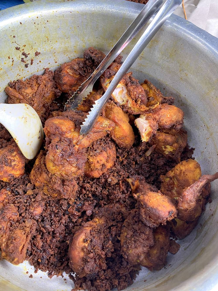 Select 'ayam goreng berempah' from the pots laid out on the table.