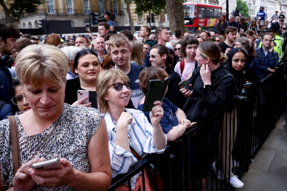 People gather outside Downing Street, where British Prime Minister Boris Johnson made a statement, in London, Britain July 7, 2022. — Reuters pic