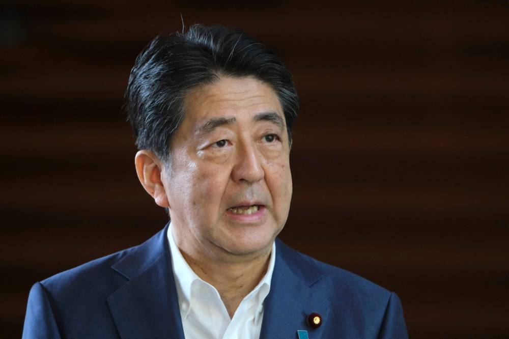 In this file photo taken on August 24, 2020, Japan's Prime Minister Shinzo Abe speaks to the media upon his arrival at the prime minister's office. — AFP pic