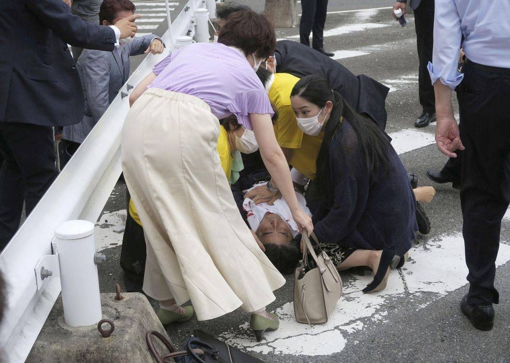 Former Japanese prime minister Shinzo Abe lies on the ground after apparent shooting during an election campaign for the July 10, 2022 Upper House election, in Nara, western Japan July 8, 2022. in this photo taken by Kyodo. — Reuters pic