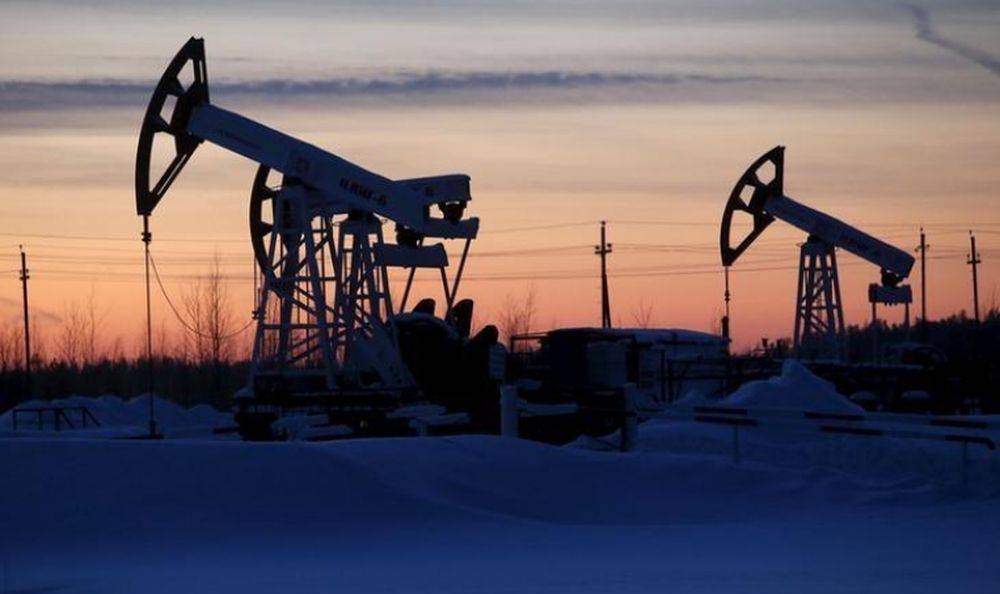 Pump jacks are seen at the Lukoil company owned Imilorskoye oil field, as the sun sets, outside the West Siberian city of Kogalym, Russia, January 25, 2016. — Reuters pic