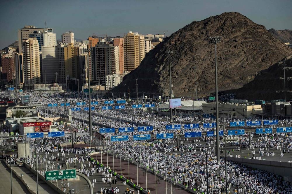 Thousands of Muslim pilgrims make their way across the valley of Mina, near Mecca in western Saudi Arabia, to perform the ‘stoning of the devil’ ritual which marks the start of the Eid al-Adha holiday on July 9, 2022, as this year's expanded hajj pilgrimage was winding down. ― AFP pic