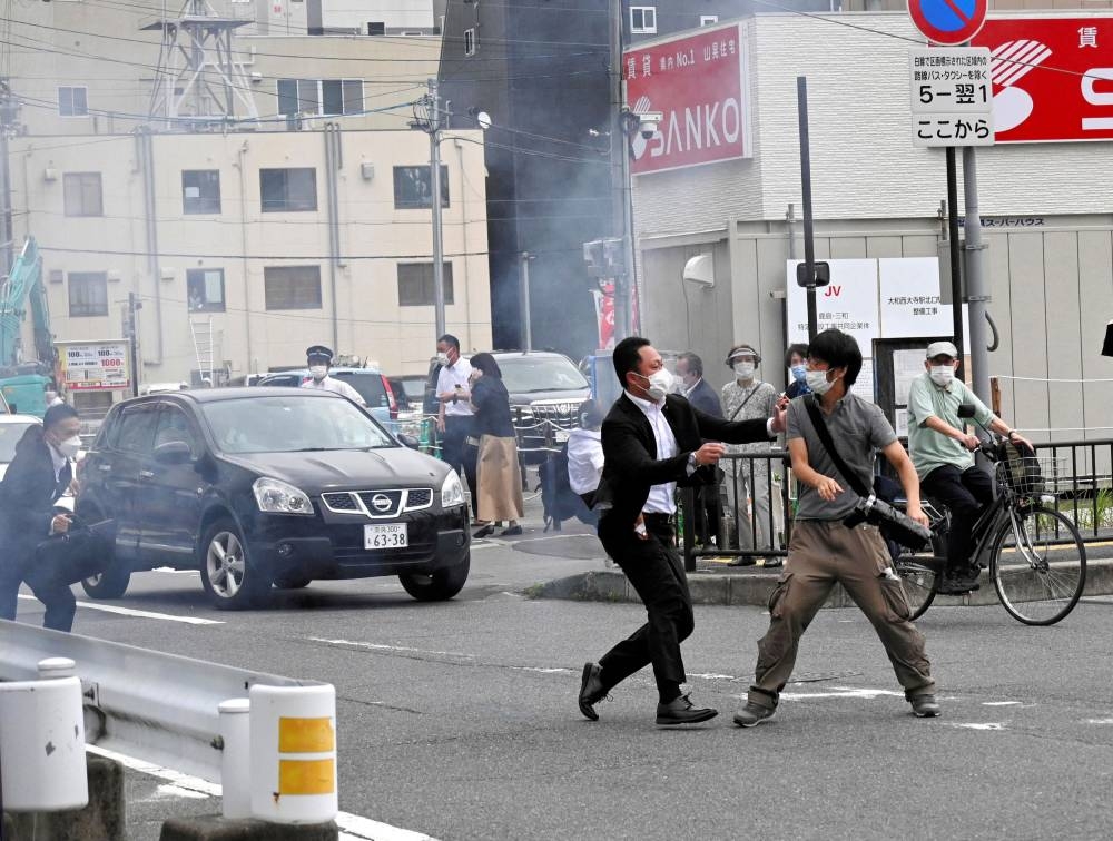 A police officer detains a man, believed to have shot former Japanese Prime Minister Shinzo Abe, in Nara, western Japan July 8, 2022 in this photo taken by The Asahi Shimbun. ― Reuters pic