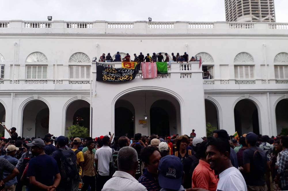 Protestors demanding the resignation of Sri Lanka’s President Gotabaya Rajapaksa gather inside the compound of Sri Lanka’s Presidential Palace in Colombo on July 9, 2022. ― AFP pic