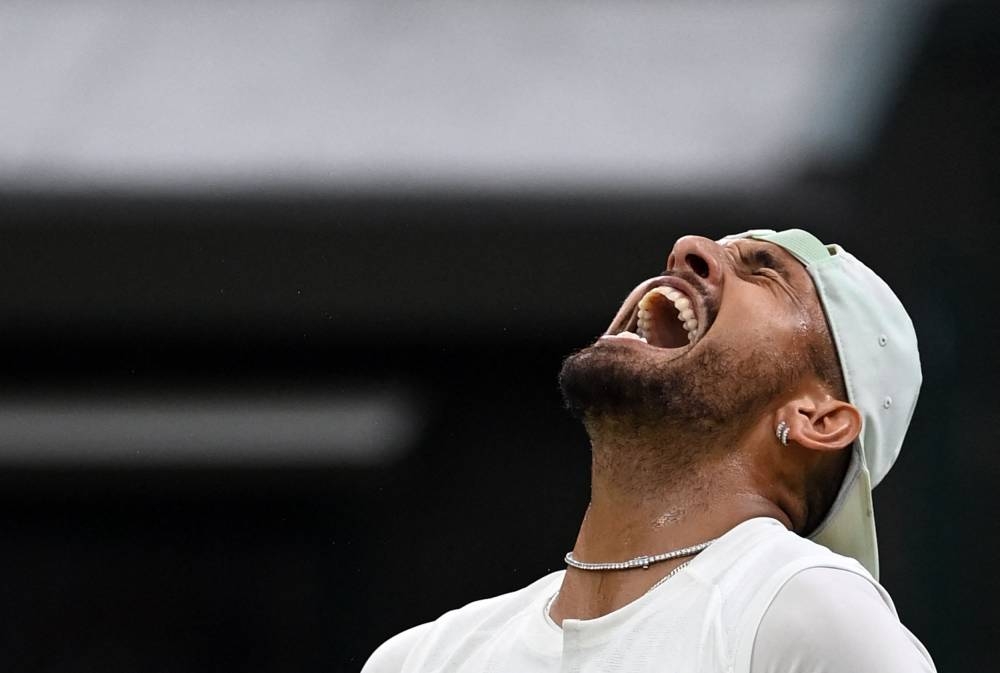 Australia's Nick Kyrgios celebrates beating Greece's Stefanos Tsitsipas during their men's singles tennis match on the sixth day of the 2022 Wimbledon Championships at The All England Tennis Club in Wimbledon, southwest London, on July 2, 2022. — AFP pic