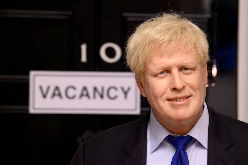 A wax figure of Boris Johnson is pictured next to a 'vacancy' sign on 10 Downing Street at Madame Tussauds, in London, Britain July 7, 2022. — Reuters pic