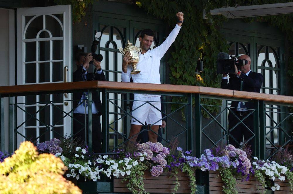 Novak Djokovic celebrates with the trophy after winning the men's singles final at the All England Lawn Tennis and Croquet Club, London July 10, 2022. — Reuters pic
