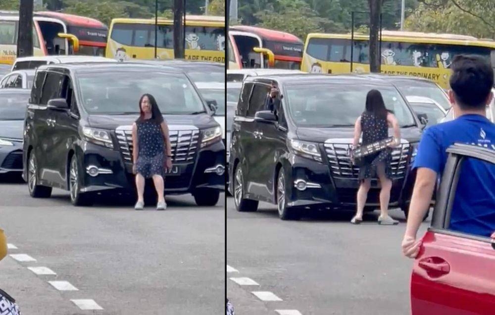 Videos of the confrontation showed a woman removing the number plate from a car and throwing it at the windscreen at the Second Link in Tuas. — Picture via TODAY