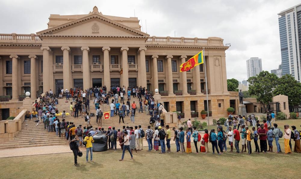 Demonstrators wait in line for breakfast after entering the Presidential Secretariat premises, after President Gotabaya Rajapaksa fled, amid the country's economic crisis, in Colombo, Sri Lanka July 10, 2022. — Reuters pic