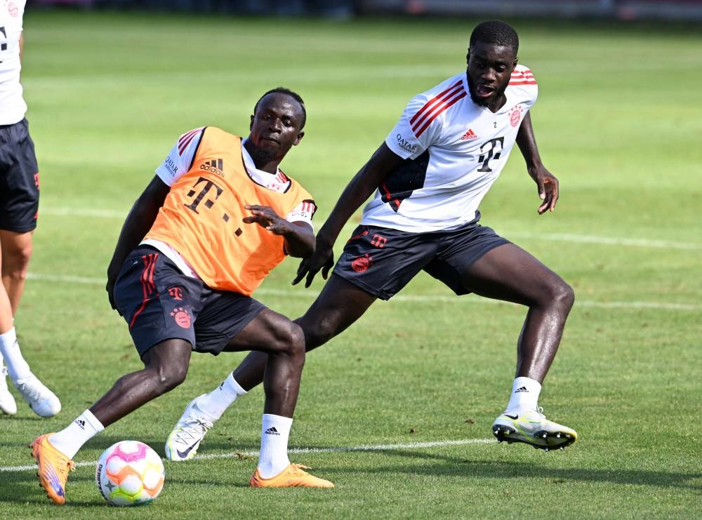 Bayern Munich's Senegalese new forward Sadio Mane (left) and Bayern Munich's French defender Dayot Upamecano (right) vie for the ball during a training session of German first division Bundesliga football team FC Bayern Munich at the club area in Munich July 8, 2022. — AFP pic