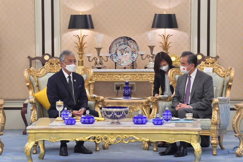 Chinese Foreign Affairs Minister Wang Yi (right) speaks to Yang di-Pertuan Agong Al-Sultan Abdullah Ri'ayatuddin Al-Mustafa Billah Shah at Istana Negara July 12. 2022. — Bernama pic