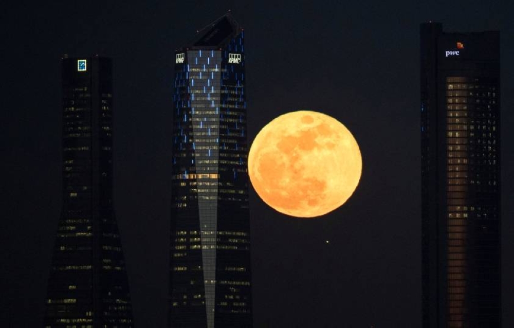 File picture of a supermoon rising in between four towers in a skyscrapers area in Madrid, Spain February 1, 2018. Malaysians will have the opportunity to witness a supermoon phenomenon, which is expected to occur at 5.09pm tomorrow. — Reuters pic