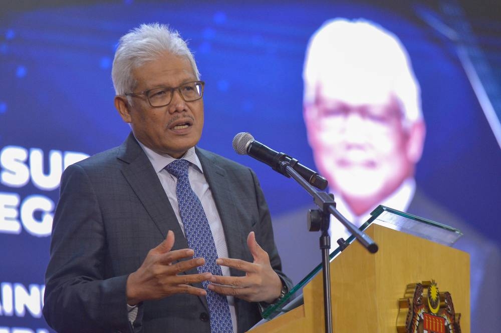 Home Minister Datuk Seri Hamzah Zainudin delivers a speech during a ceremony to present citizenship approval letters to 28 recipient in Putrajaya, July 13, 2022. — Picture by Shafwan Zaidon