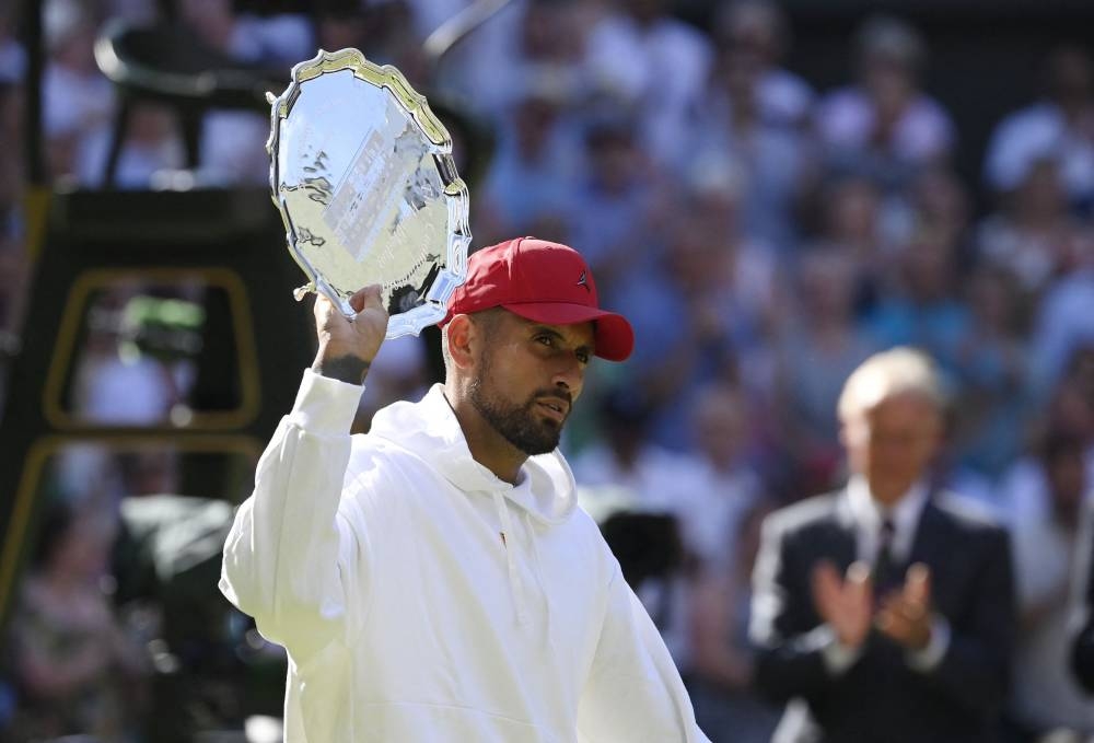 Australia's Nick Kyrgios with the runners up trophy after losing the men's singles final against Serbia's Novak Djokovic at the All England Lawn Tennis and Croquet Club, London July 10, 2022. — Reuters pic