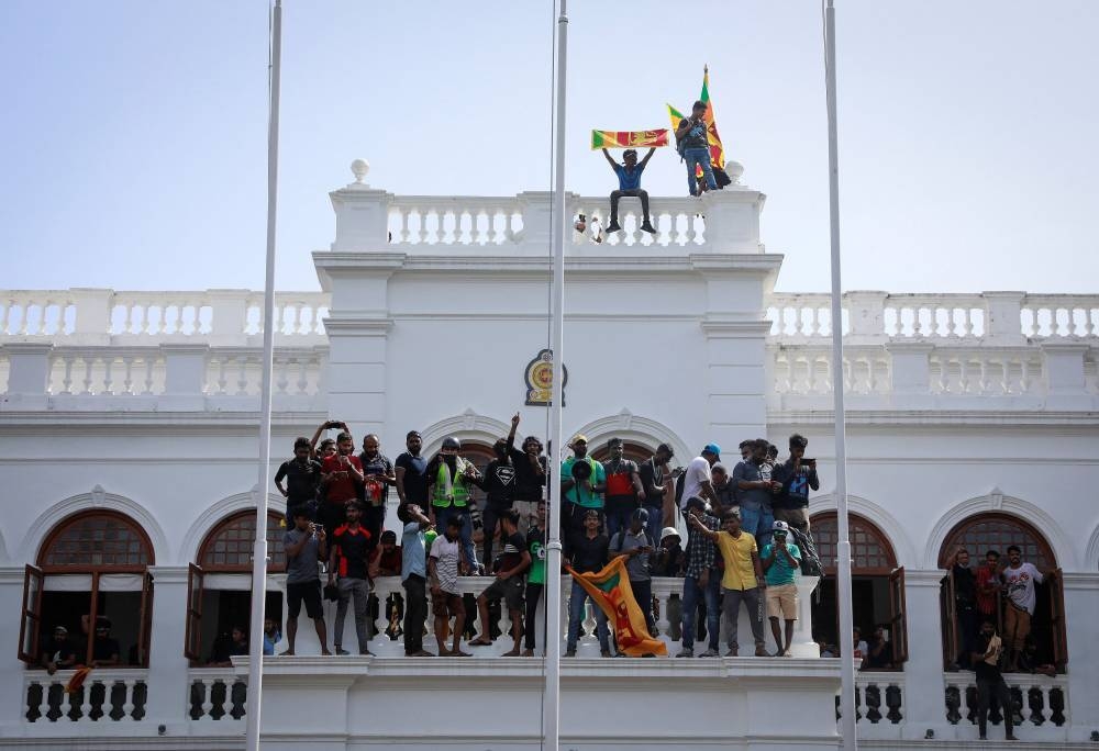 Protestors celebrate after entering the building of Sri Lanka's Prime Minister Ranil Wickremesinghe's office, amid the country's economic crisis, in Colombo, Sri Lanka July 13, 2022. — Reuters pic