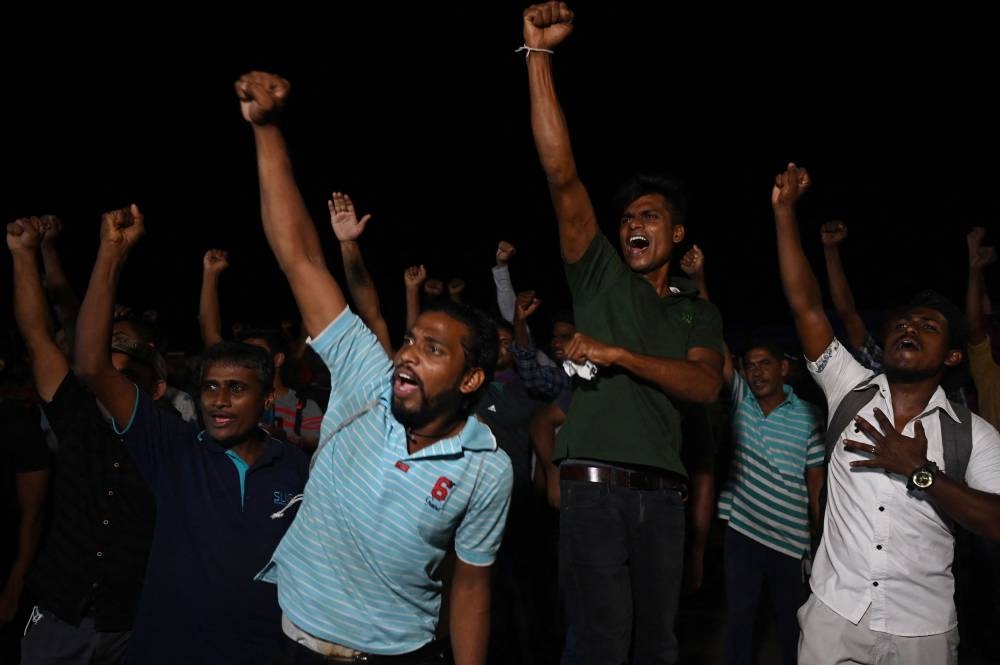 People celebrate the resignation of Sri Lanka's President, in Colombo on July 14, 2022. — AFP pic
