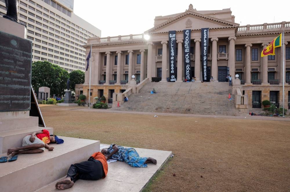 Demonstrators sleep at the Presidential Secretariat after Parliament Speaker Mahinda Yapa Abeywardena officially announced the resignation of president Gotabaya Rajapaksa who fled to Singapore amid Sri Lanka's economic crisis, in Colombo, Sri Lanka, July 15, 2022. — Reuters pic