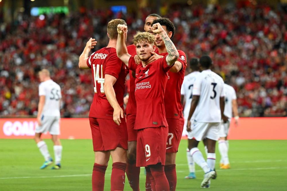 Liverpool midfielder Jordan Henderson celebrates with Harvey Elliott and teammates after scoring a goal during the exhibition match against Crystal Palace FC at the National Stadium in Singapore, July 15, 2022. — AFP pic 