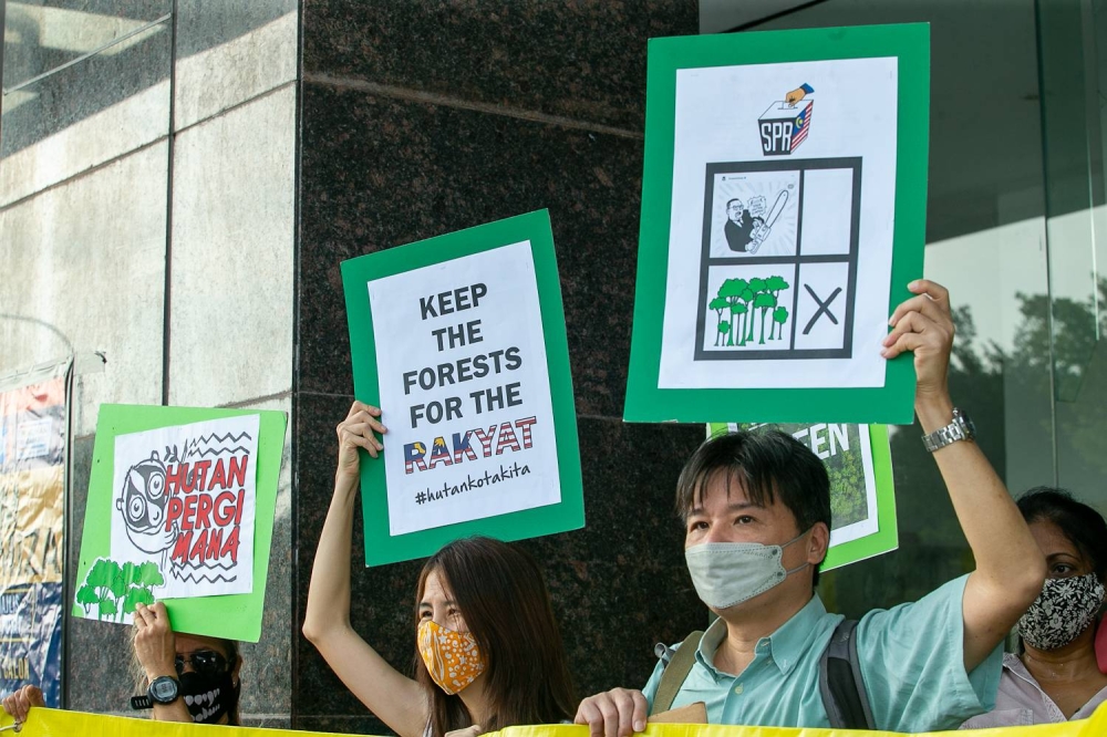 SACF demonstrators holding placards at IDDC Shah Alam this morning, July 16, 2022. — Picture by Devan Manuel