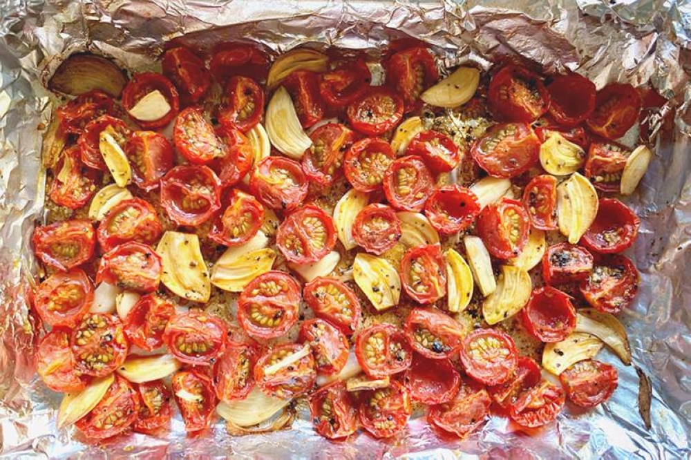 Roast the cherry tomatoes and garlic together in one tray.