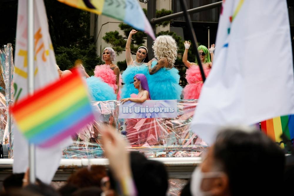 A participant waves rainbow flags during the Korea Queer Culture Festival 2022 in central Seoul, South Korea, July 16, 2022. — Reuters pic