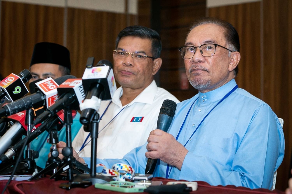 PKR president Datuk Seri Anwar Ibrahim (right) speaks during a press conference at the PKR National Conference in Shah Alam. July 16, 2022 — Picture by Devan Manuel