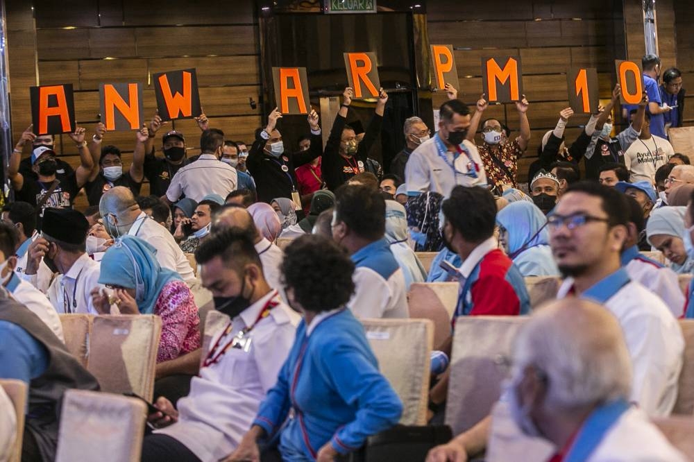 PKR members hold up placards to spell out 'Anwar PM 10' at the 16th PKR Congress in Ideal Convention Centre (IDCC) Shah Alam July 17, 2022. — Picture by Hari Anggara