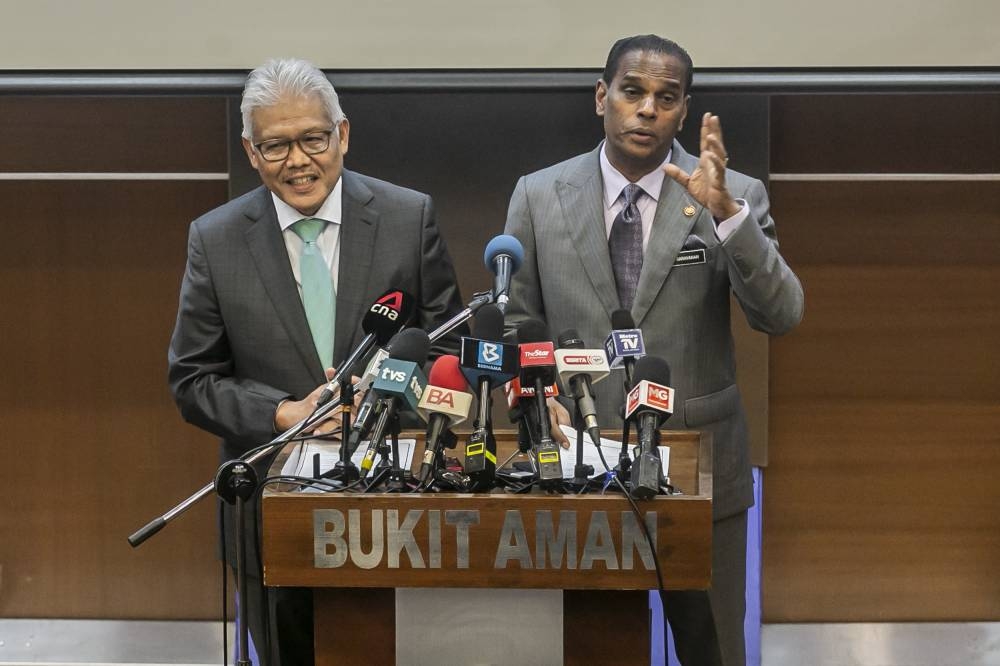 Home Minister Datuk Seri Hamzah Zainudin with Human Resources Minister Datuk Seri M. Saravanan (right) at the press conference after the Committee on Foreign Workers Management meeting at Royal Malaysia Police Headquarters, Bukit Aman, July 18, 2022. — Picture by Hari Anggara