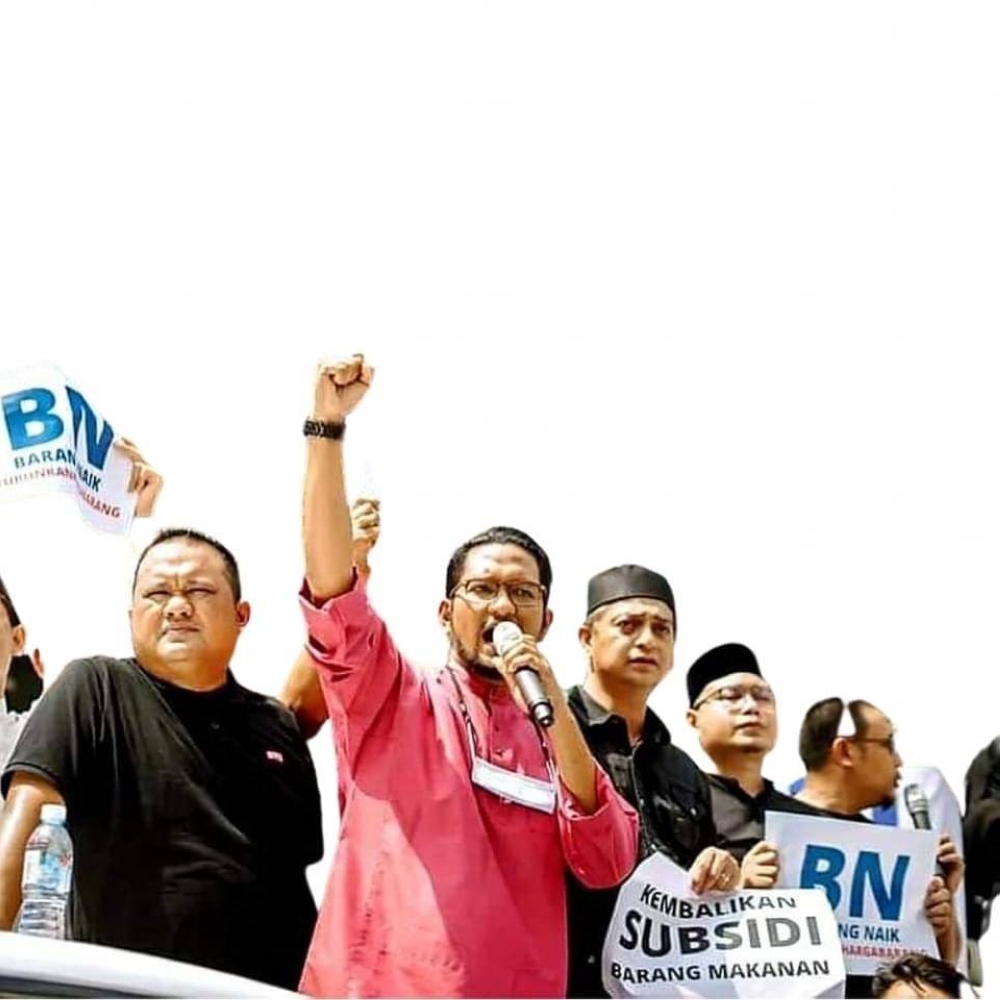 An undated picture of Johor DAP’s Sheikh Umar Bagharib Ali (centre) participating in a protest over the rising cost of living recently. — Picture courtesy of Facebook