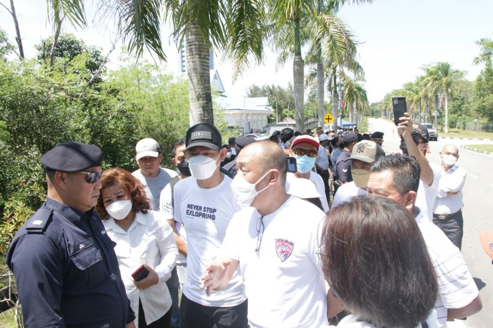 Members of Solidariti Anak Sabah walk from Menara Kinabalu to the gates of the state assembly building in Kota Kinabalu July 19, 2022. — Picture by Julia Chan