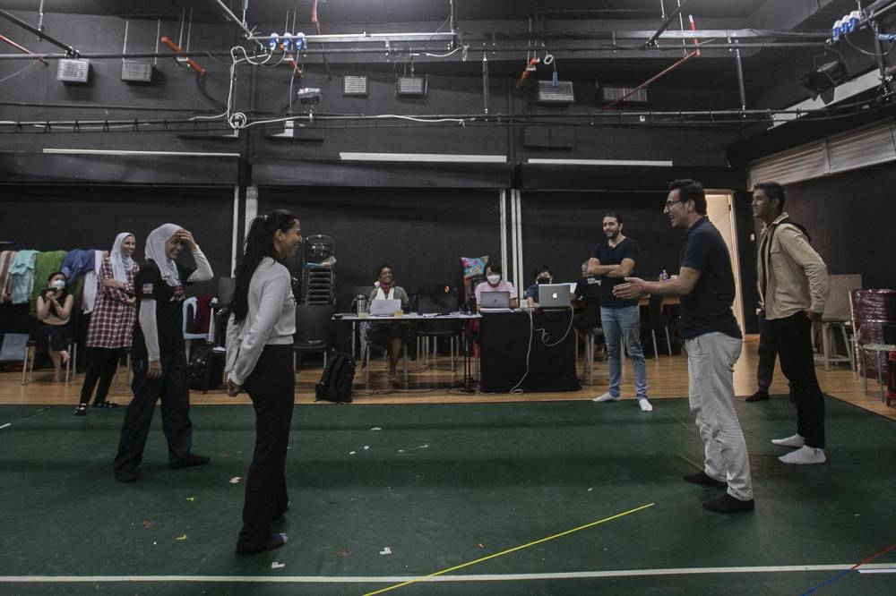 Director Saleh Sepas (right) shares a lighthearted moment with actors during play rehearsals at the Five Arts Centre in GMBB, Kuala Lumpur. — Pictures by Hari Anggara