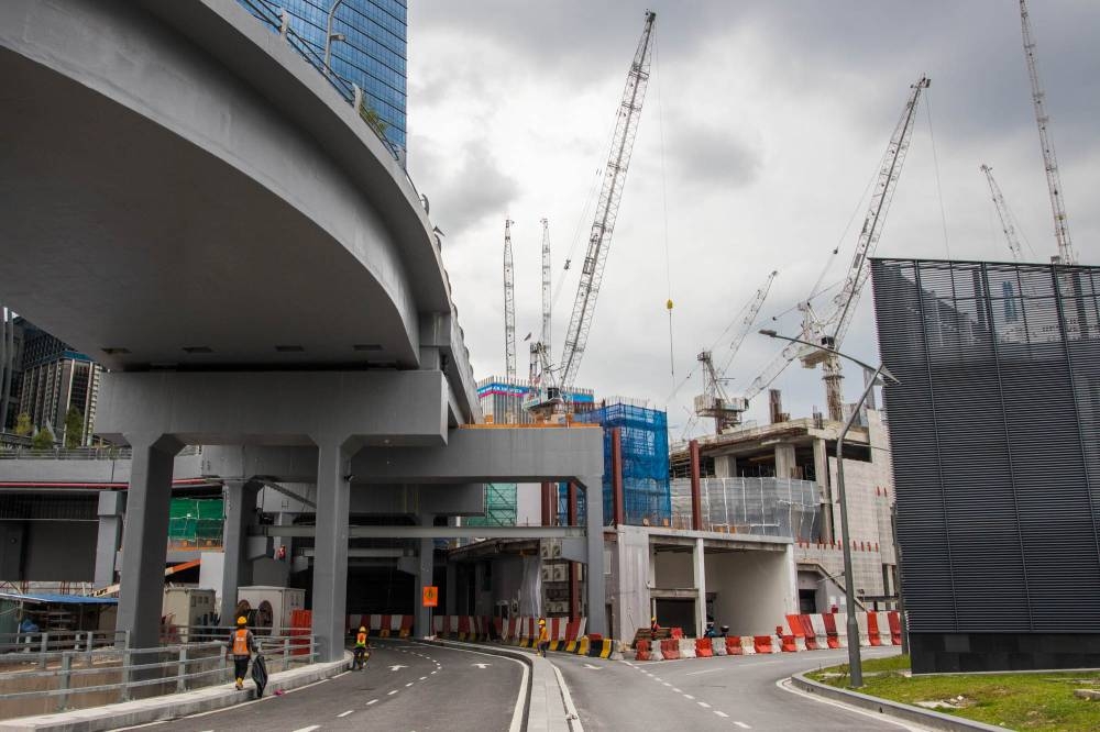 File picture of cranes and material at a construction site near the Tun Razak Exchange (TRX) financial district in Kuala Lumpur, October 28, 2021. — Picture by Firdaus Latif 