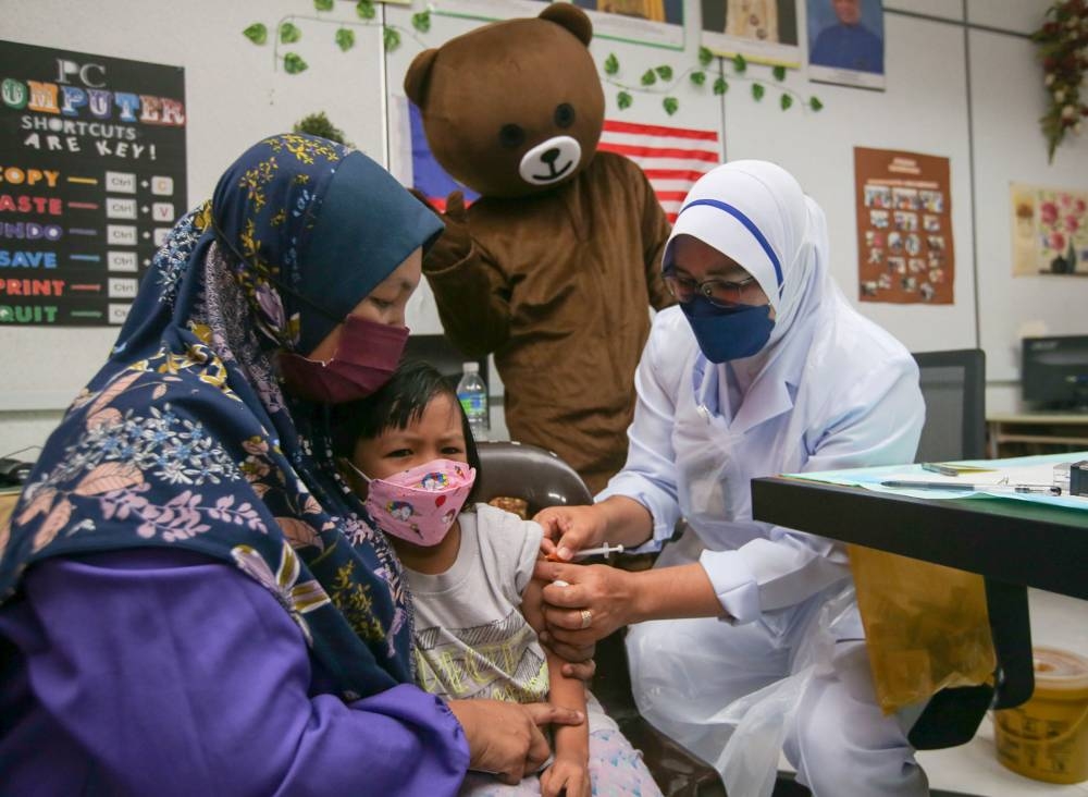 A girl receives her Covid-19 vaccination at a kindergarten in Perak in this February 28, 2022 file photograph. — Picture by Farhan Najib