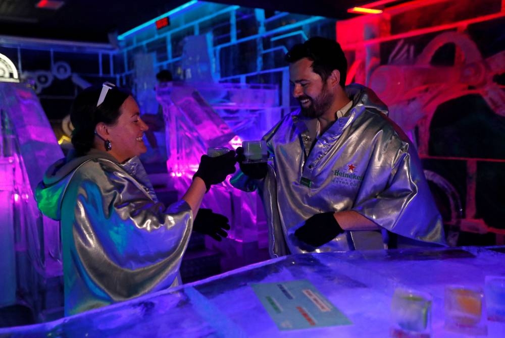 Customers drink from glasses made of ice inside the Ice Pub in Prague, Czech Republic July 19, 2022. — Reuters pic