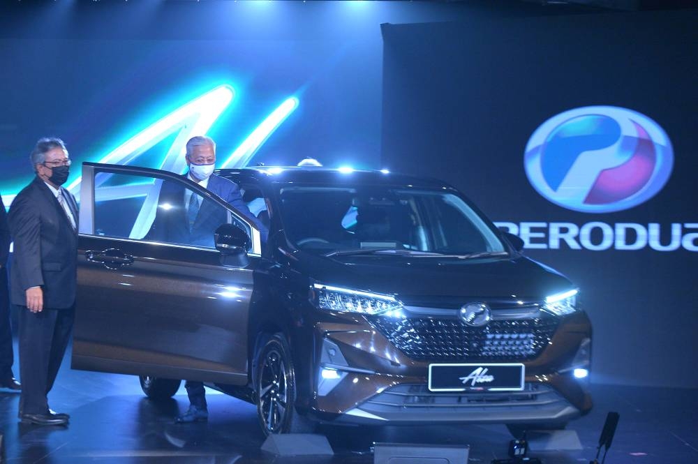 Prime Minister Datuk Seri Ismail Sabri Yaakob takes a look at the all new Perodua Alza during its launch at the Kuala Lumpur Convention Centre July 20, 2022. — Picture by Shafwan Zaidon