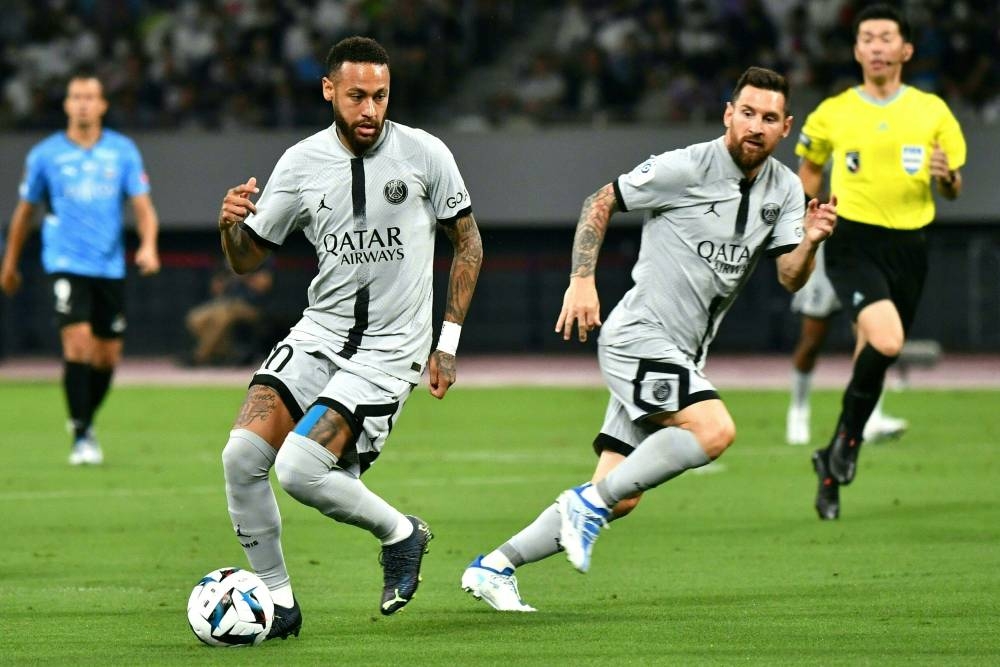 Paris Saint-Germain's Brazilian forward Neymar (left) controls the ball next to Argentinian forward Lionel Messi (right) during PSG's Japan Tour football match against Kawasaki Frontale at the National Stadium in Tokyo on July 20, 2022. — AFP pic
