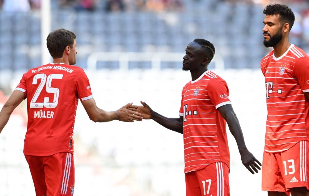 Bayern Munich's new recruit Senegalese forward Sadio Mane (centre) and Bayern Munich's German forward Thomas Mueller (left) and Bayern Munich's Cameroonian forward Eric Maxim Choupo-Moting (right) attend the team presentation of the German first division Bundesliga team FC Bayern Munich at the Allianz Arena in Munich, southern Germany, on July 16, 2022. — AFP pic
