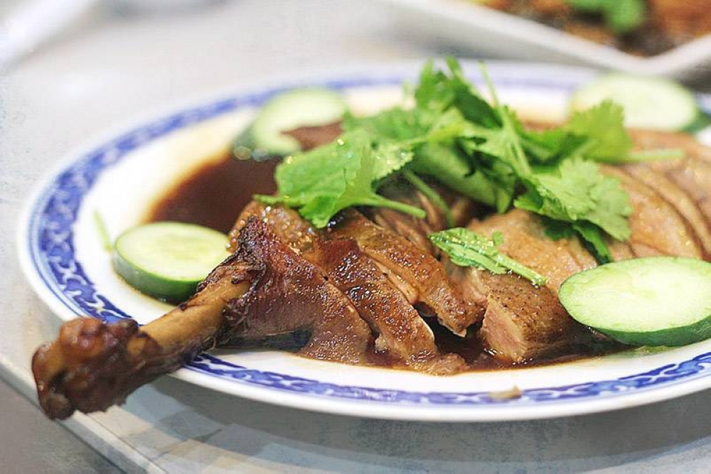 The duck after it has been sliced and doused with the braising gravy.