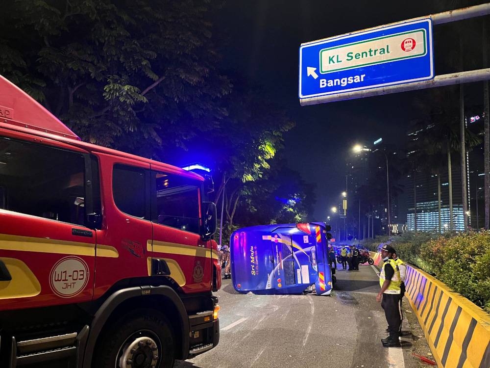 Kuala Lumpur Fire and Rescue Department personnel work to rescue passengers from an express bus that overturned at Jalan Damansara in Kuala Lumpur July 20, 2022. — Picture via Facebook/Bomba Kuala Lumpur