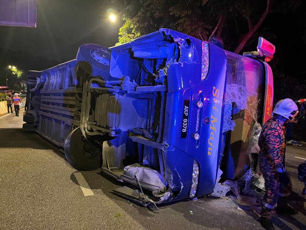 Kuala Lumpur Fire and Rescue Department personnel work to rescue passengers from an express bus that overturned at Jalan Damansara in Kuala Lumpur July 20, 2022. — Picture via Facebook/Bomba Kuala Lumpur