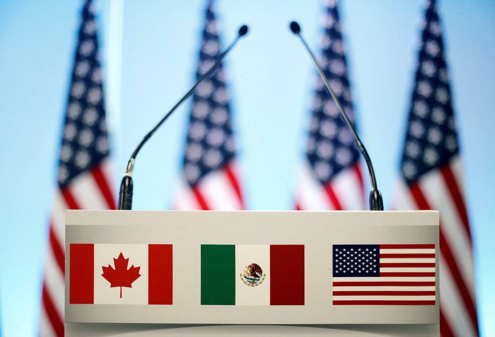 The flags of Canada, Mexico and the US are seen on a lectern before a joint news conference on the closing of the seventh round of Nafta talks in Mexico City March 5, 2018. — Reuters pic