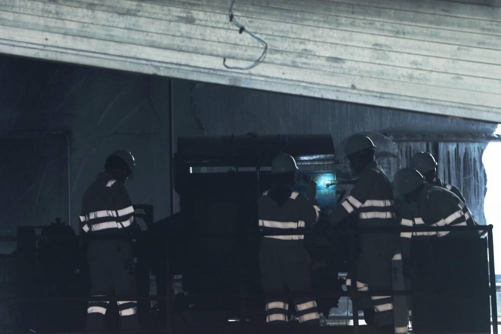 Members of an inquiry committee visiting the site at 32E Tuas Avenue 11, where an explosion and fire killed and injured several workers on February 24, 2021. ― TODAY pic